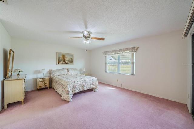 carpeted bedroom featuring a textured ceiling and ceiling fan