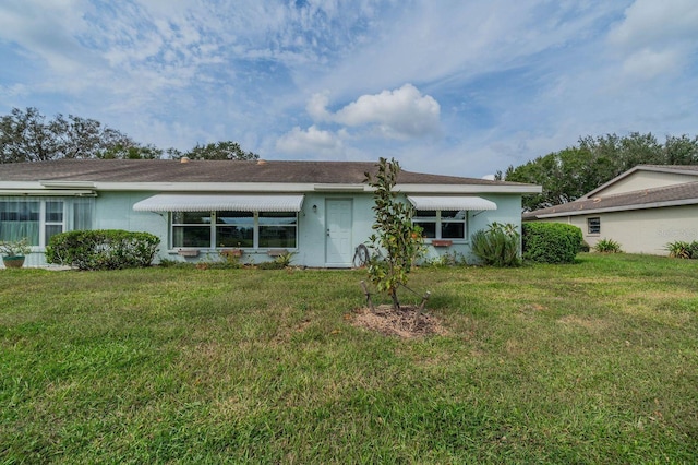 rear view of house with a yard