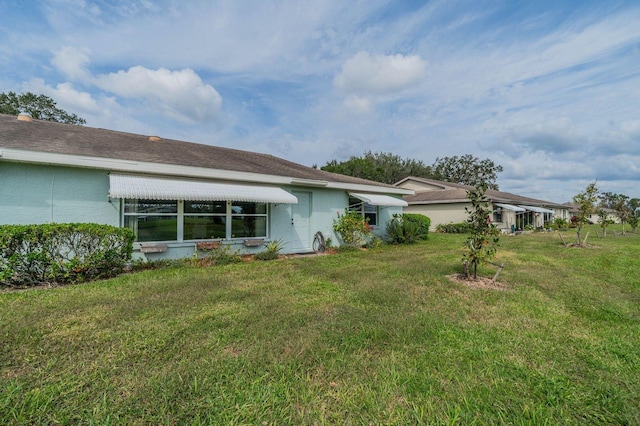 rear view of house with a yard