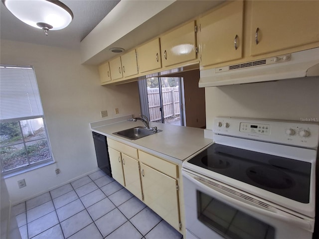 kitchen featuring dishwasher, sink, light tile patterned floors, and electric stove