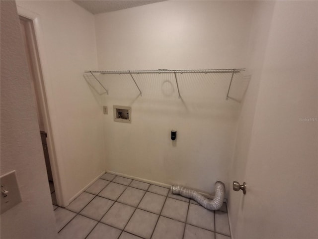 clothes washing area featuring light tile patterned flooring, washer hookup, and electric dryer hookup