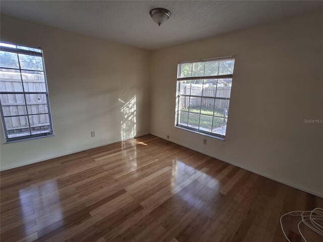 spare room with hardwood / wood-style floors