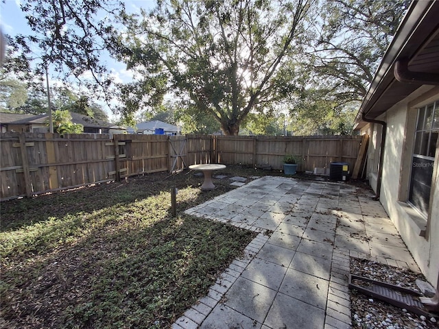 view of yard featuring a patio area and central AC unit