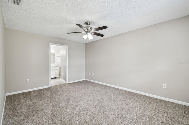 unfurnished bedroom featuring ceiling fan, connected bathroom, a textured ceiling, and light colored carpet