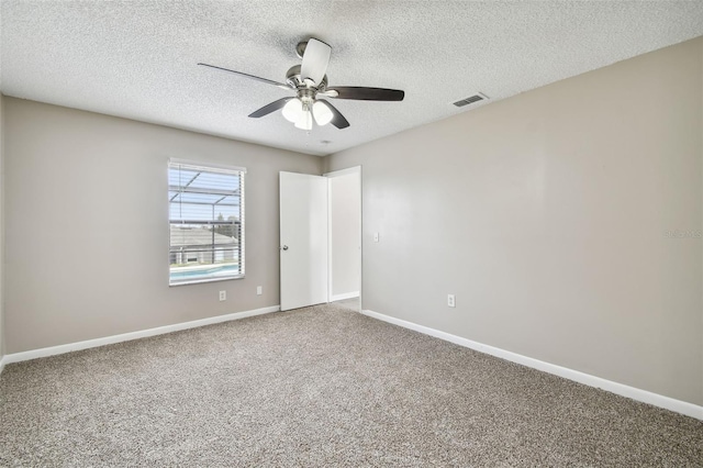 unfurnished room with carpet flooring, a textured ceiling, and ceiling fan