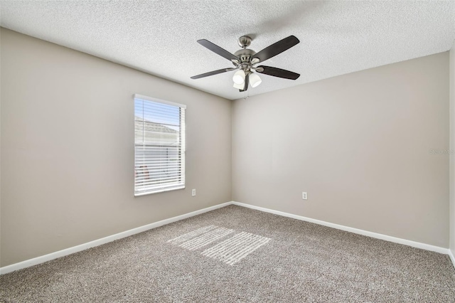 spare room featuring carpet, a textured ceiling, and ceiling fan