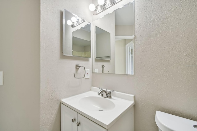 bathroom with toilet and vanity