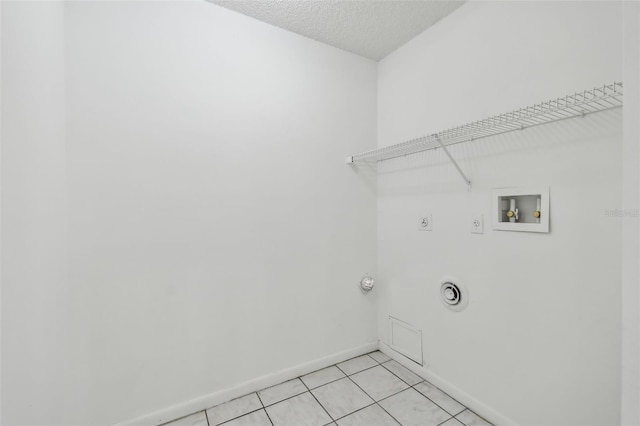 laundry area featuring hookup for a washing machine, light tile patterned floors, electric dryer hookup, and a textured ceiling