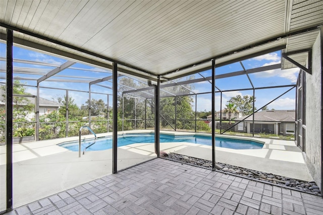 view of pool with a patio and glass enclosure