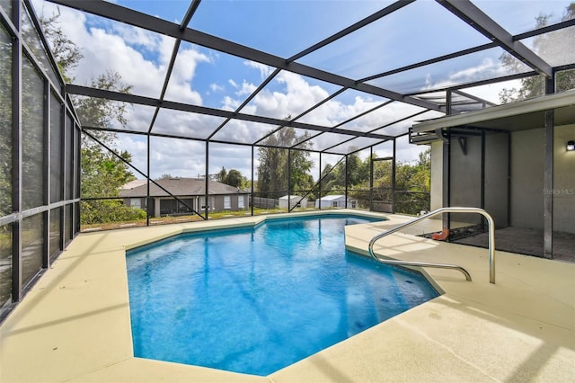 view of swimming pool with a patio and glass enclosure