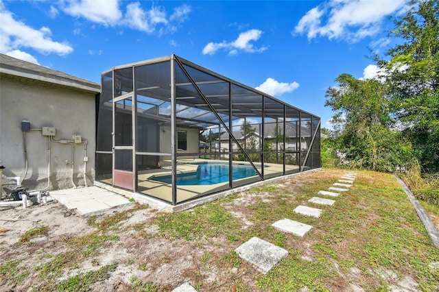 view of swimming pool featuring a lanai and a patio area