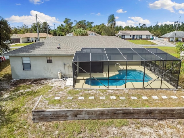 back of house with a patio and glass enclosure