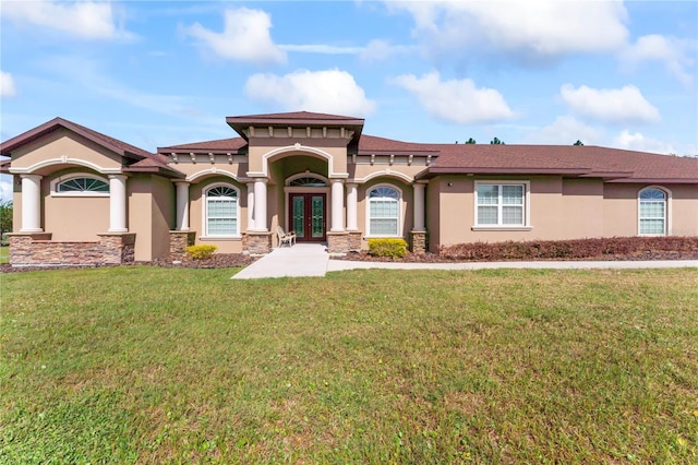 view of front of property featuring french doors and a front lawn