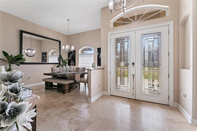 entrance foyer featuring french doors and a chandelier