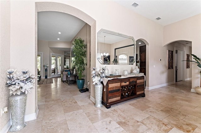 hallway featuring a chandelier