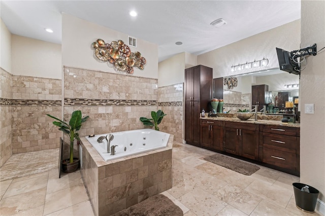 bathroom featuring tile walls, vanity, and separate shower and tub