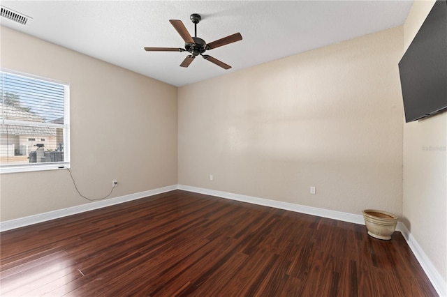 unfurnished room featuring a textured ceiling, dark hardwood / wood-style floors, and ceiling fan