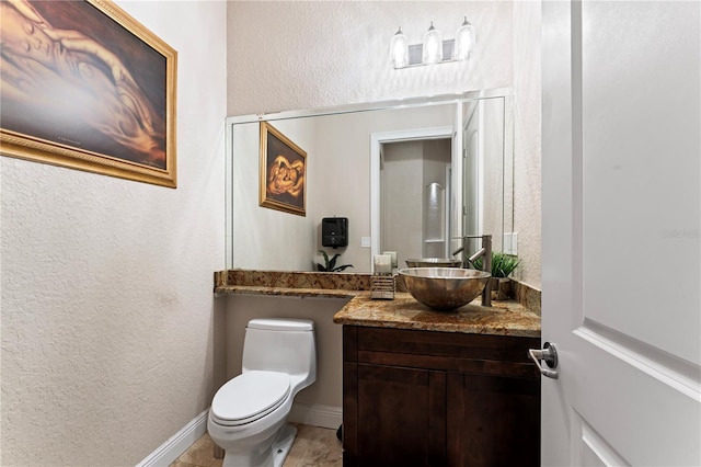 bathroom with toilet and vanity