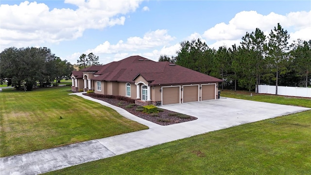 view of front of home with a front lawn and a garage