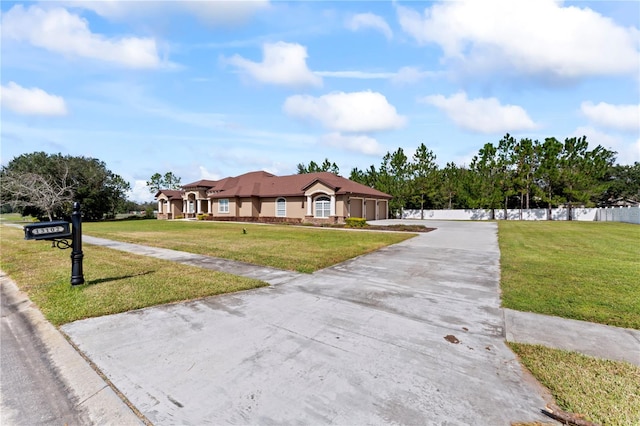 ranch-style home with a front yard and a garage