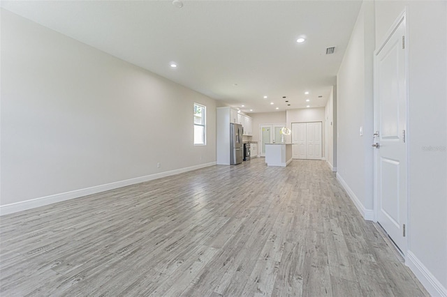 unfurnished living room with light hardwood / wood-style flooring