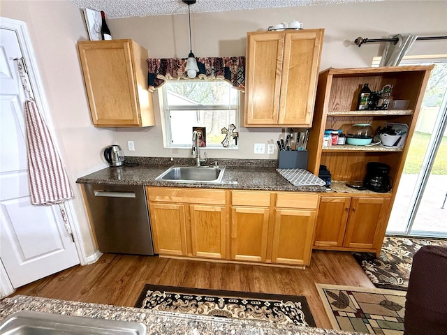 kitchen with a textured ceiling, light hardwood / wood-style flooring, dishwasher, decorative light fixtures, and sink