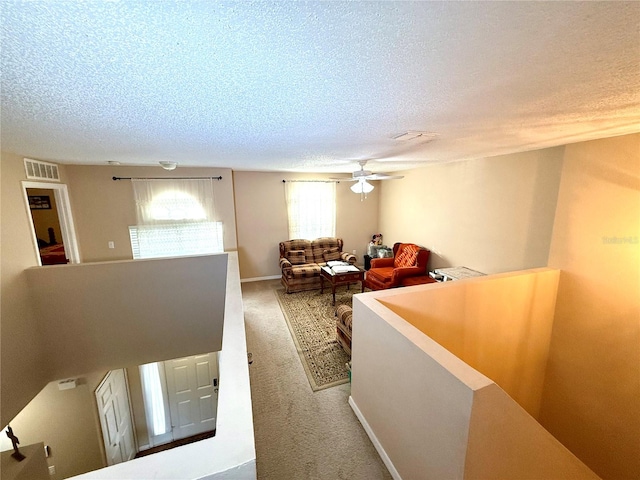 interior space featuring a textured ceiling and ceiling fan