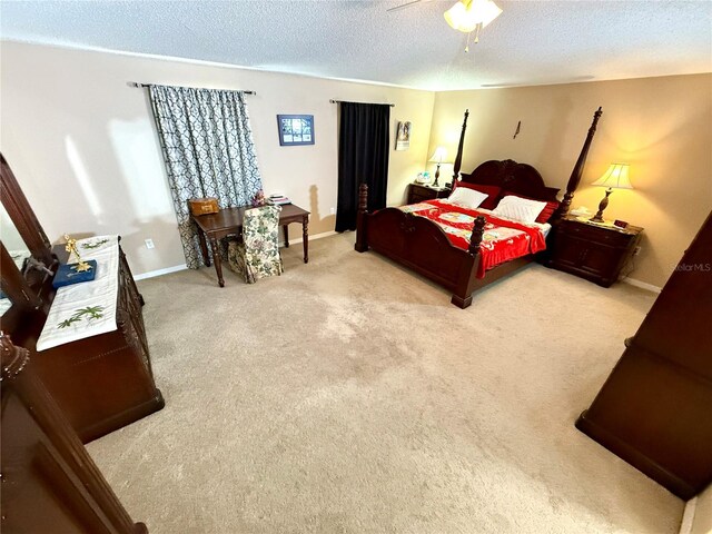 bedroom with ceiling fan, a textured ceiling, and light colored carpet