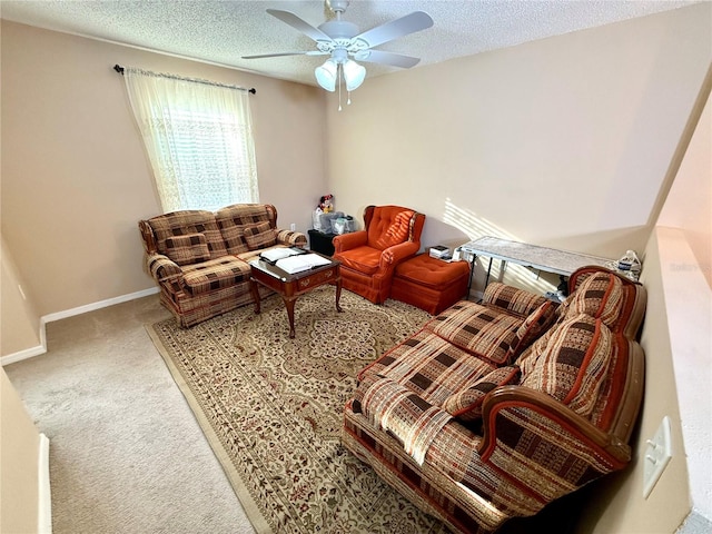 carpeted living room with a textured ceiling and ceiling fan