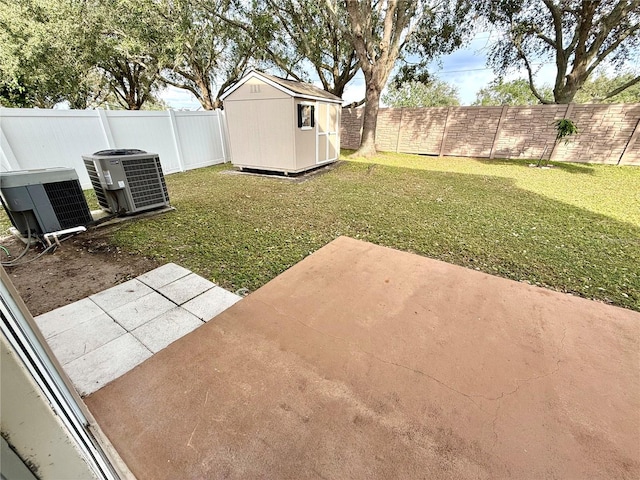 view of yard with a patio, a storage unit, and central AC unit