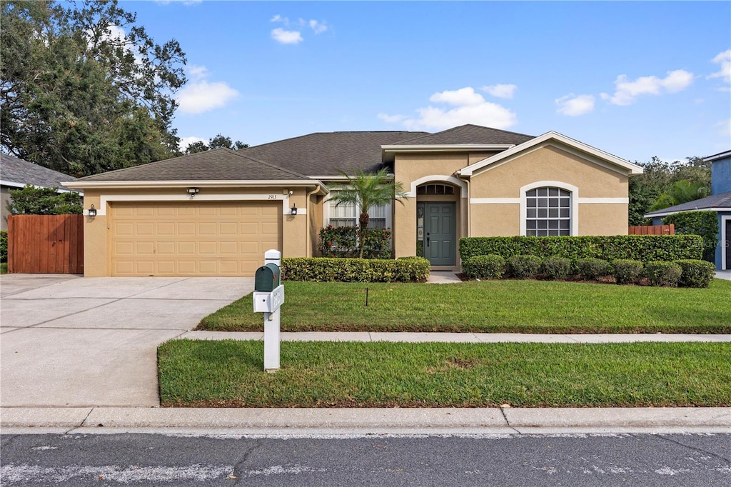 ranch-style house with a front lawn and a garage