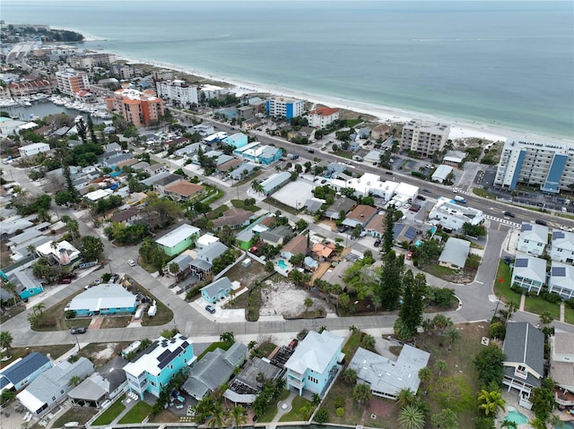 birds eye view of property with a water view and a view of the beach