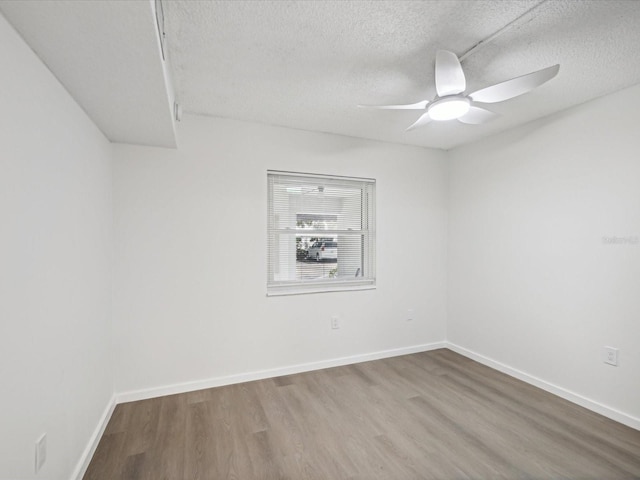 spare room featuring hardwood / wood-style flooring, a textured ceiling, and ceiling fan