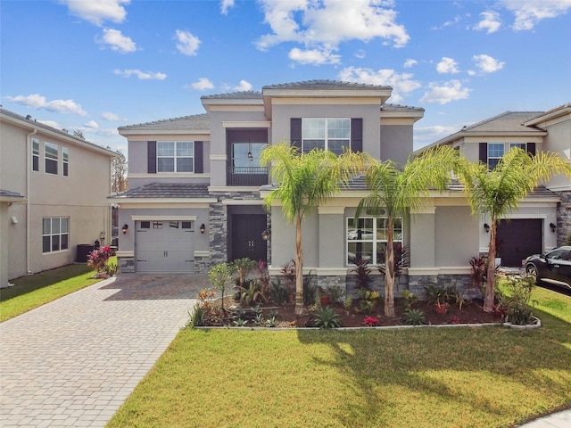 view of front of property featuring a garage and a front yard