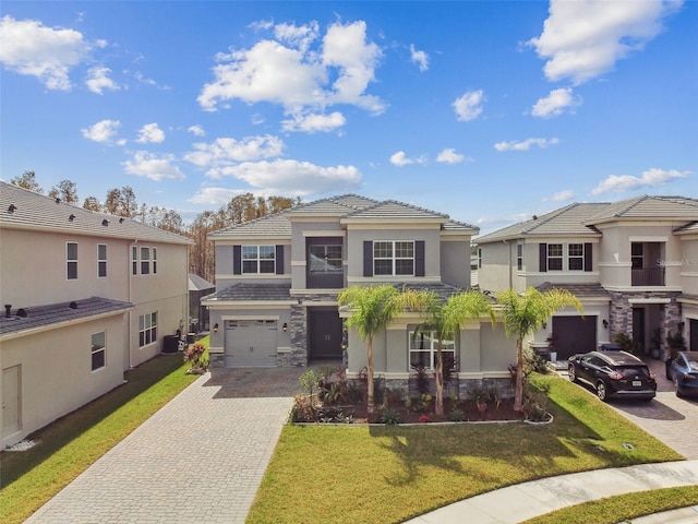 view of front of house with a garage and a front yard