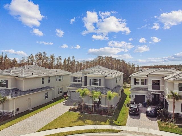 exterior space featuring a garage and a front lawn