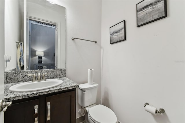 bathroom featuring toilet and vanity