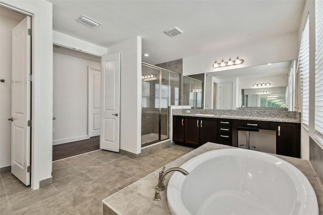 bathroom featuring tile patterned flooring, vanity, and separate shower and tub