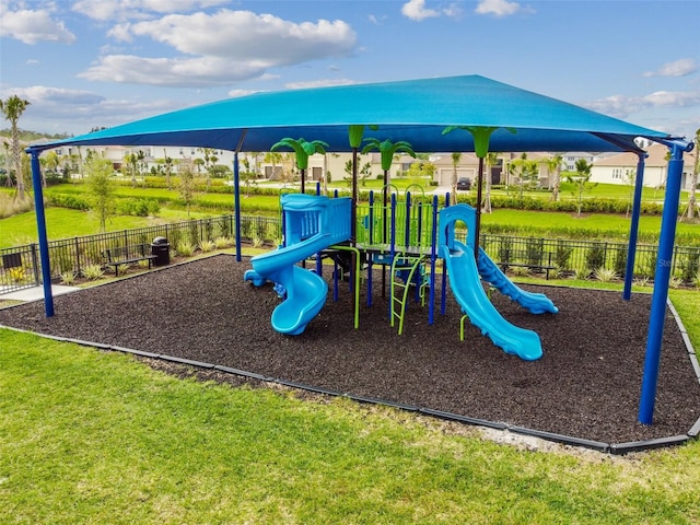 view of playground with a lawn