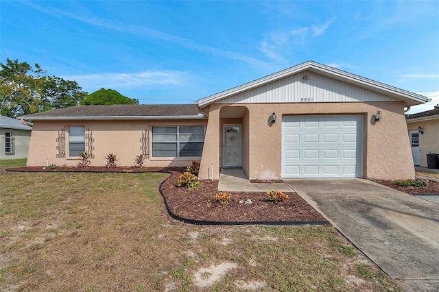 ranch-style home with a garage and a front lawn