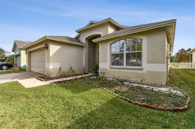 view of front of home with a front lawn and a garage