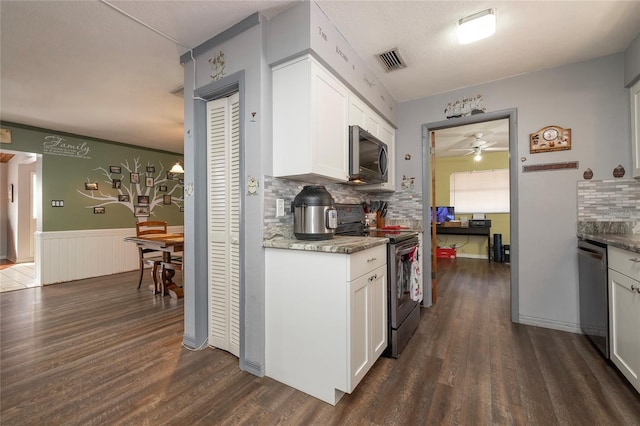 kitchen featuring stainless steel appliances, white cabinetry, and backsplash