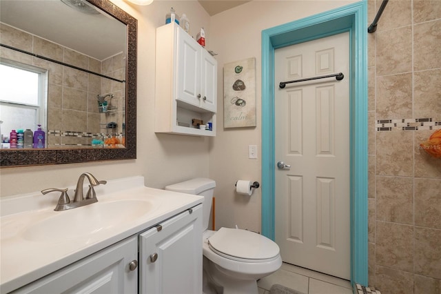 bathroom featuring tile patterned flooring, vanity, and toilet