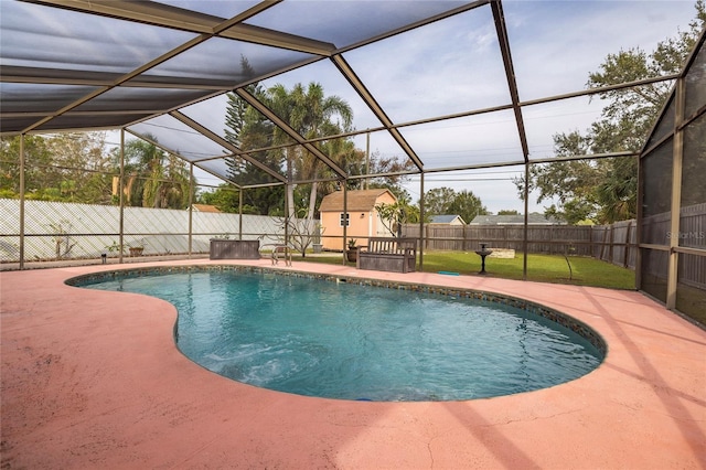 view of swimming pool featuring a storage shed, a lanai, a patio area, and a yard