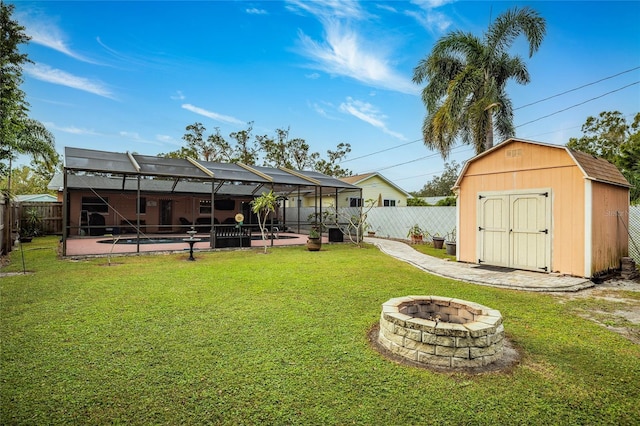 view of yard with a lanai, a storage unit, a fenced in pool, a fire pit, and a patio