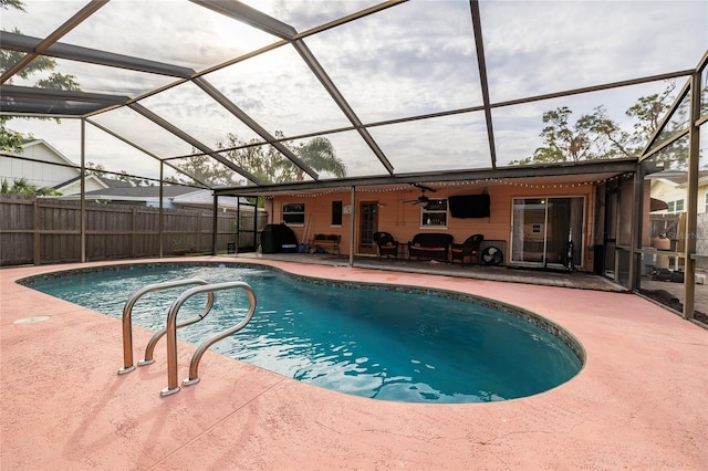 view of pool featuring a lanai, a patio, and ceiling fan