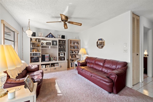 living room with light carpet, a textured ceiling, and ceiling fan