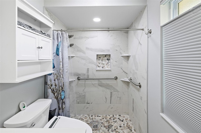 bathroom featuring toilet and walk in shower