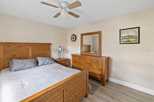 bedroom featuring ceiling fan and light hardwood / wood-style flooring