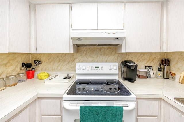 kitchen with electric range and tasteful backsplash